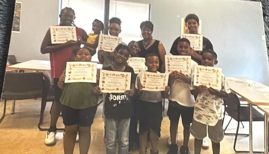 MHHFO youth participants proudly holding certificates alongside founder Shernavian Roper Vandiber